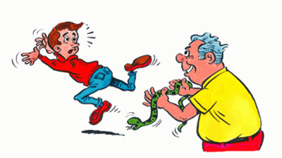 A boy is running away from a man who has a snake in his hands.